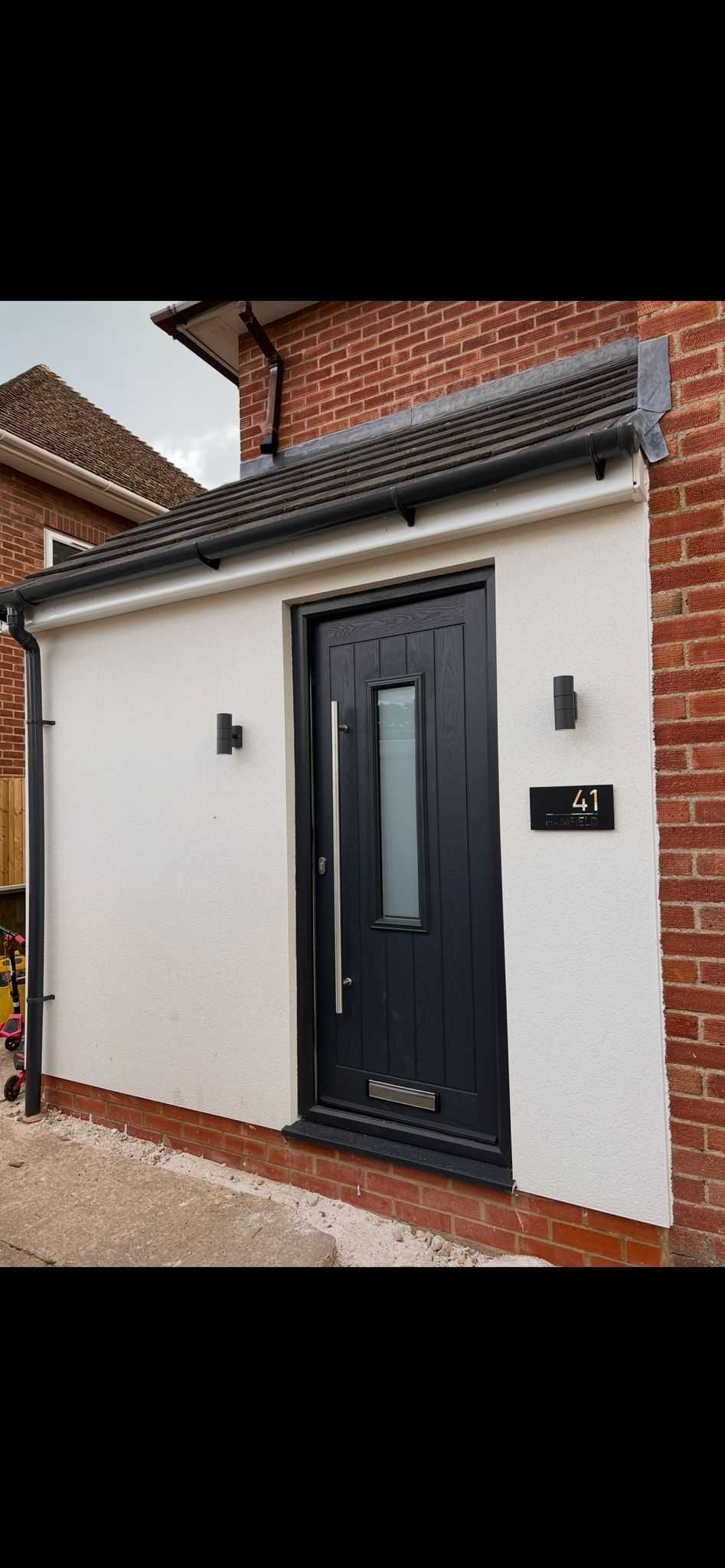 Modern grey composite door with house number 41 and exterior lighting
