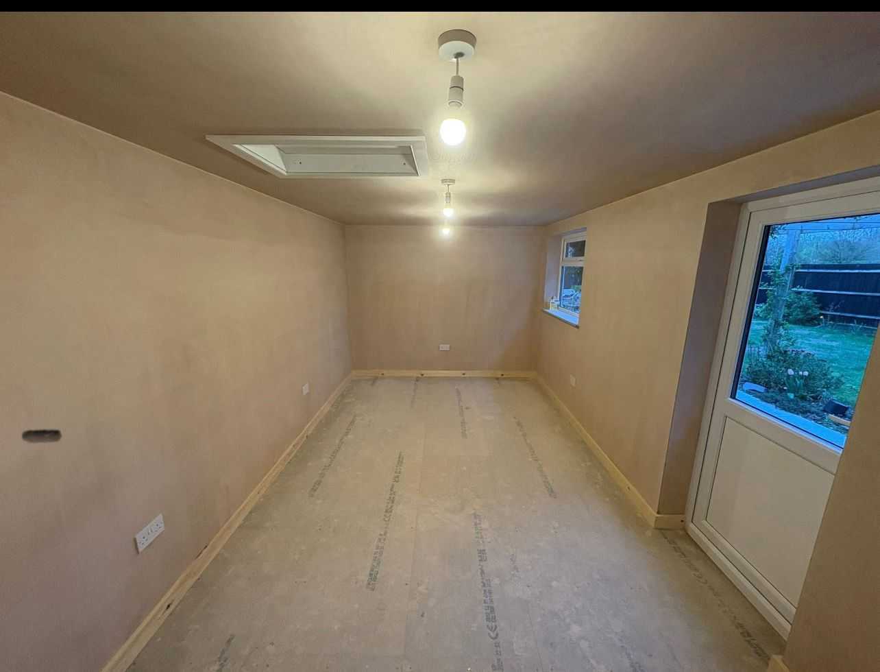 Interior of newly plastered extension room ready for finishing in Bicester, Oxfordshire