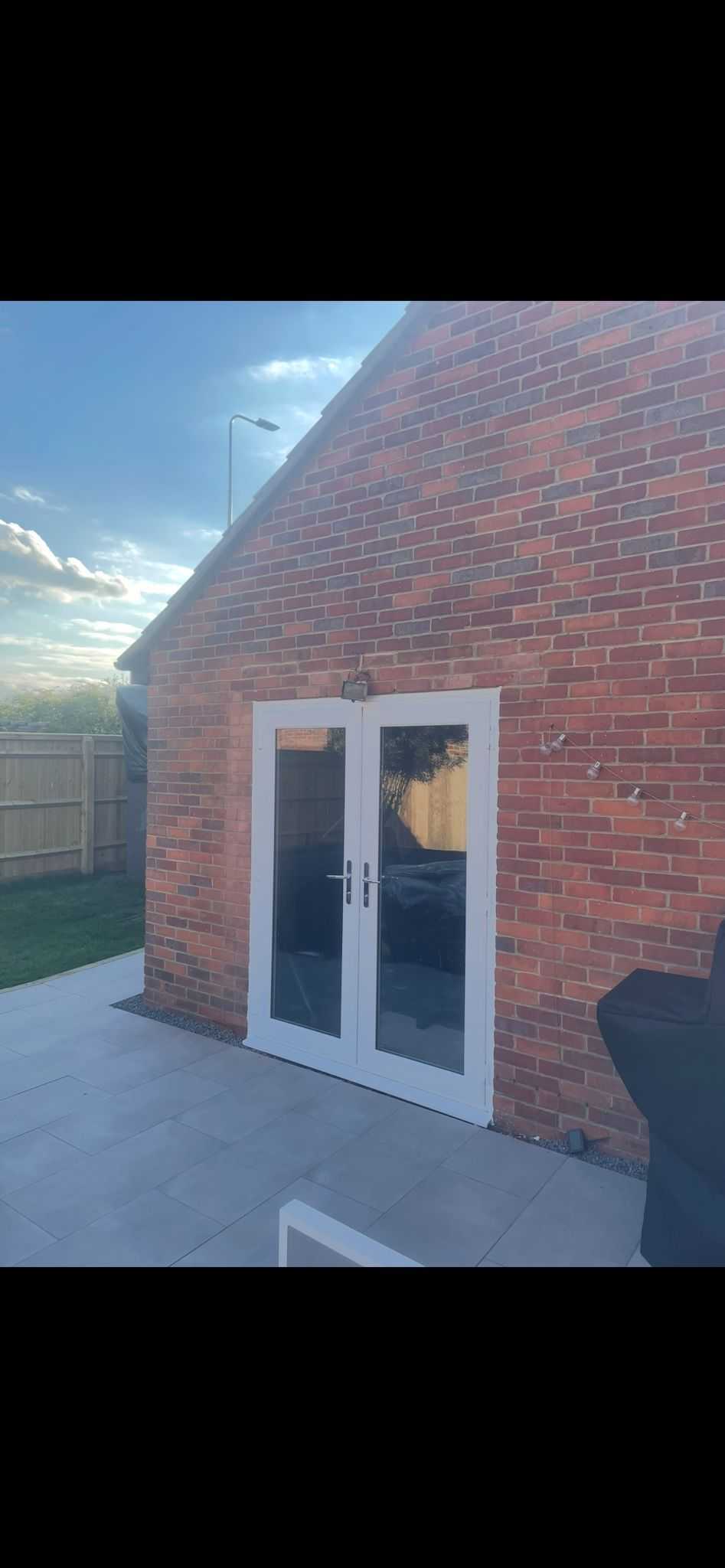White uPVC patio doors on new extension with beautiful outdoor patio in Oxford