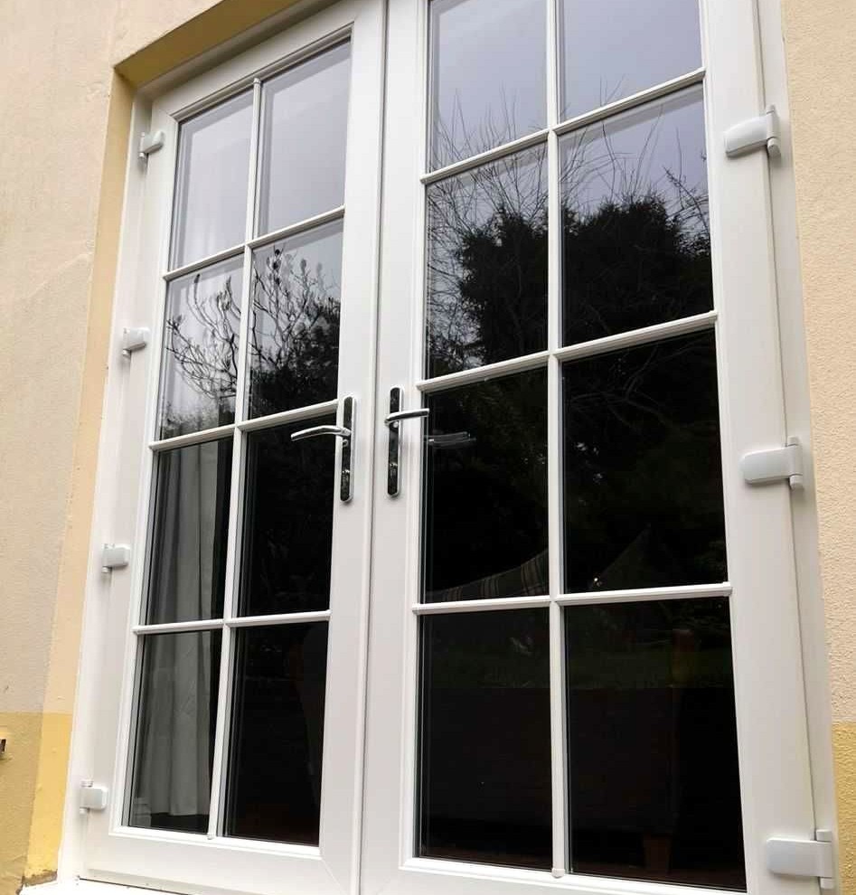 White uPVC French doors with Georgian bars by CJB Renovations