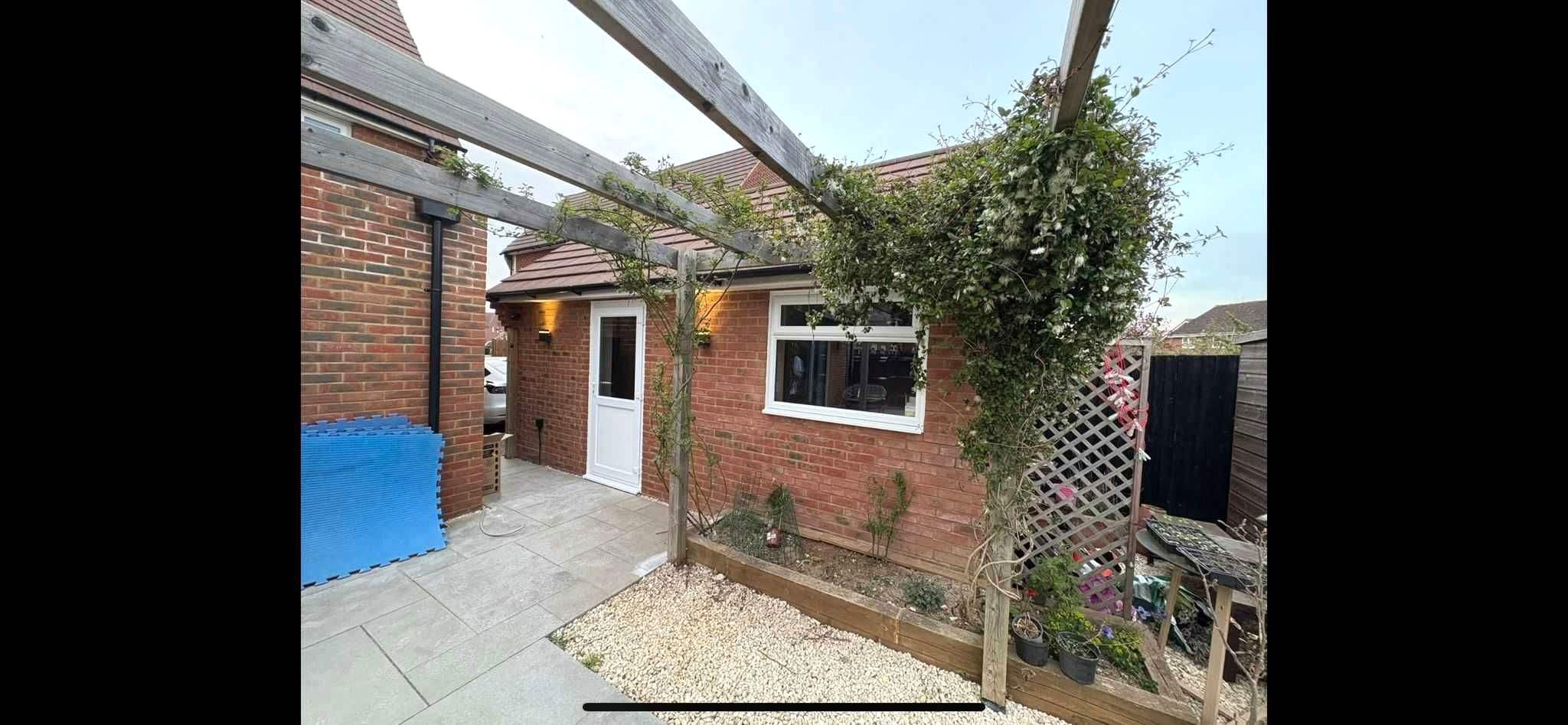 Garage conversion with outdoor living space by CJB Renovations