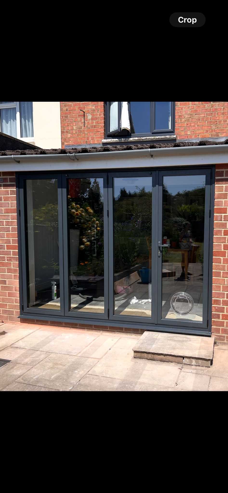 Large grey sliding bi-fold doors installation on patio in Oxfordshire
